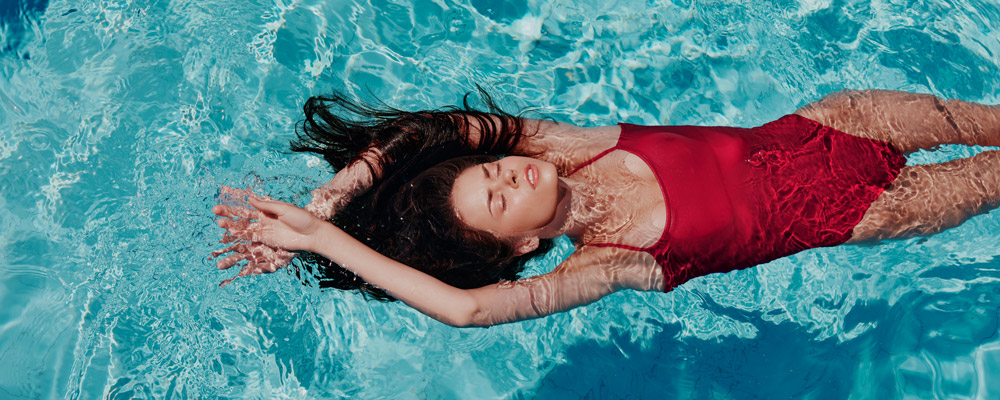 Woman with closed eyes in the pool at Relaxia Olivina hotel